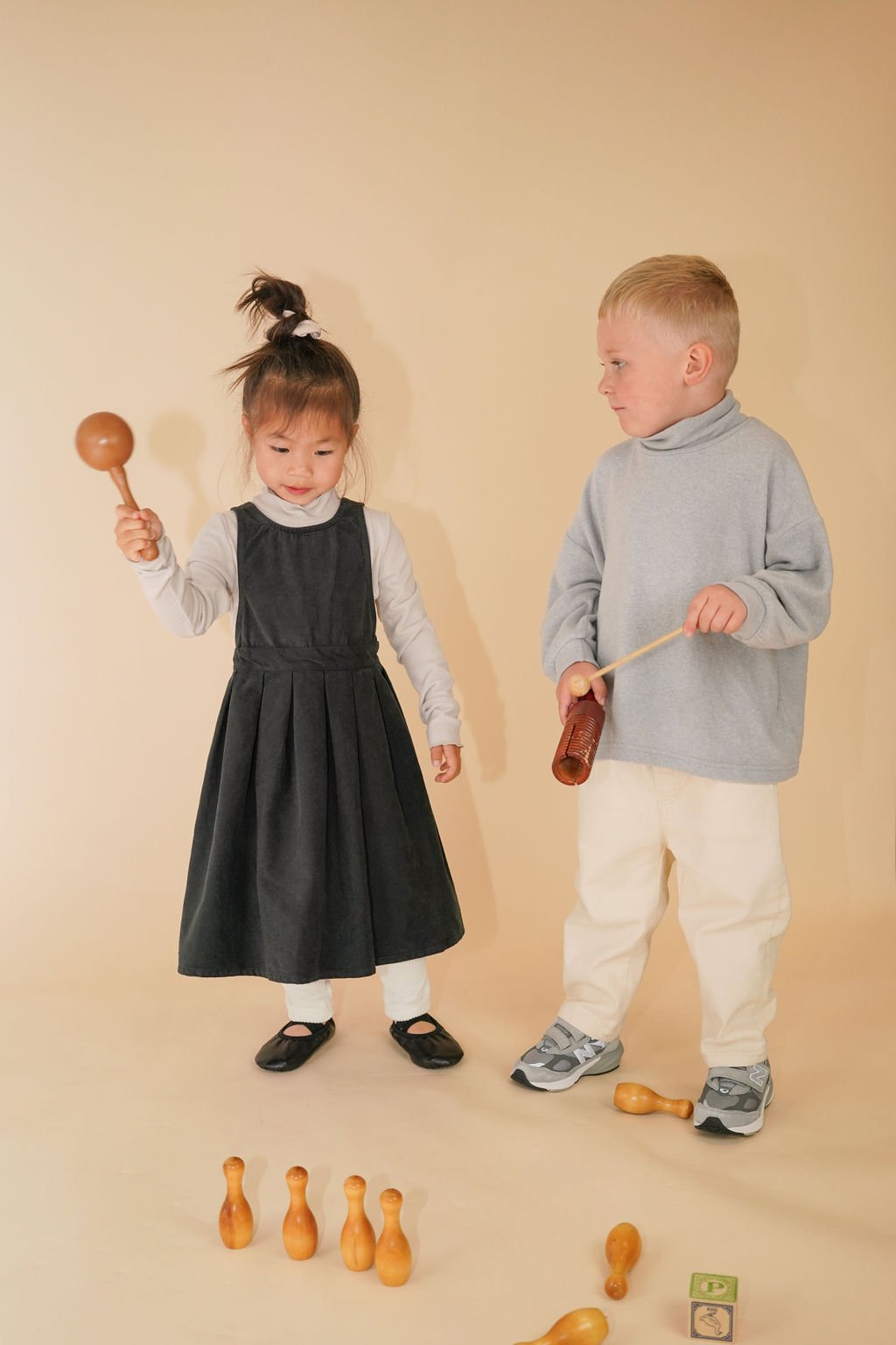 Side view of kids' brushed twill pull-up pants in cream, highlighting the relaxed fit, elastic waistband, and durable fabric with a slightly stretchy feel