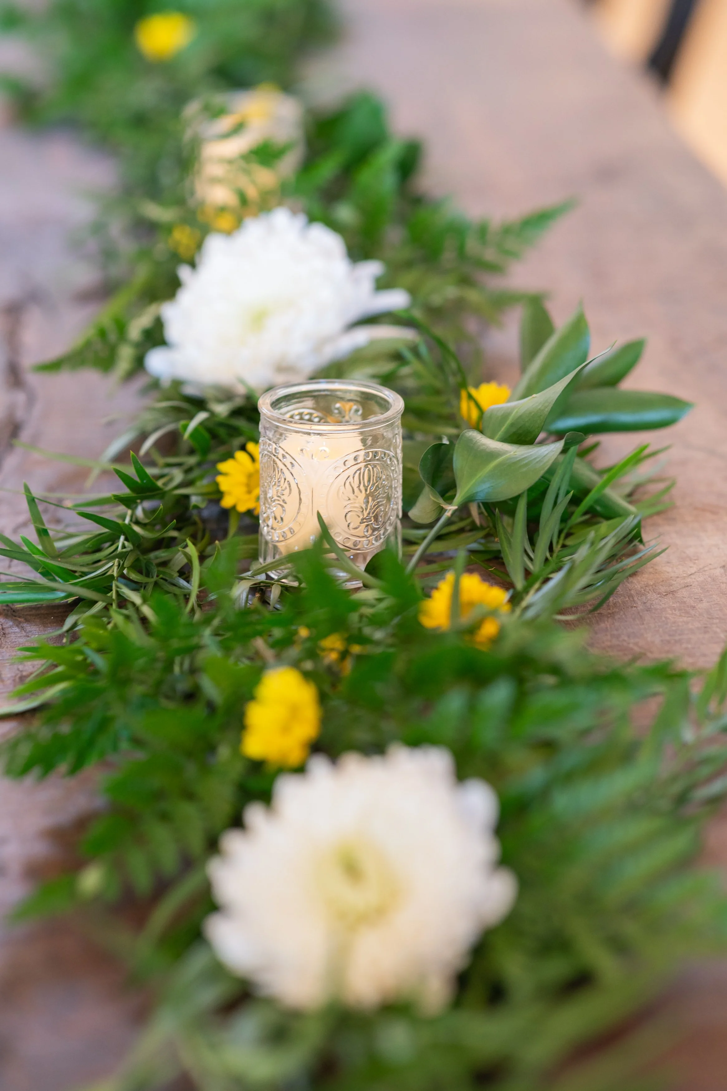 Available greenery and glass votive candle holders