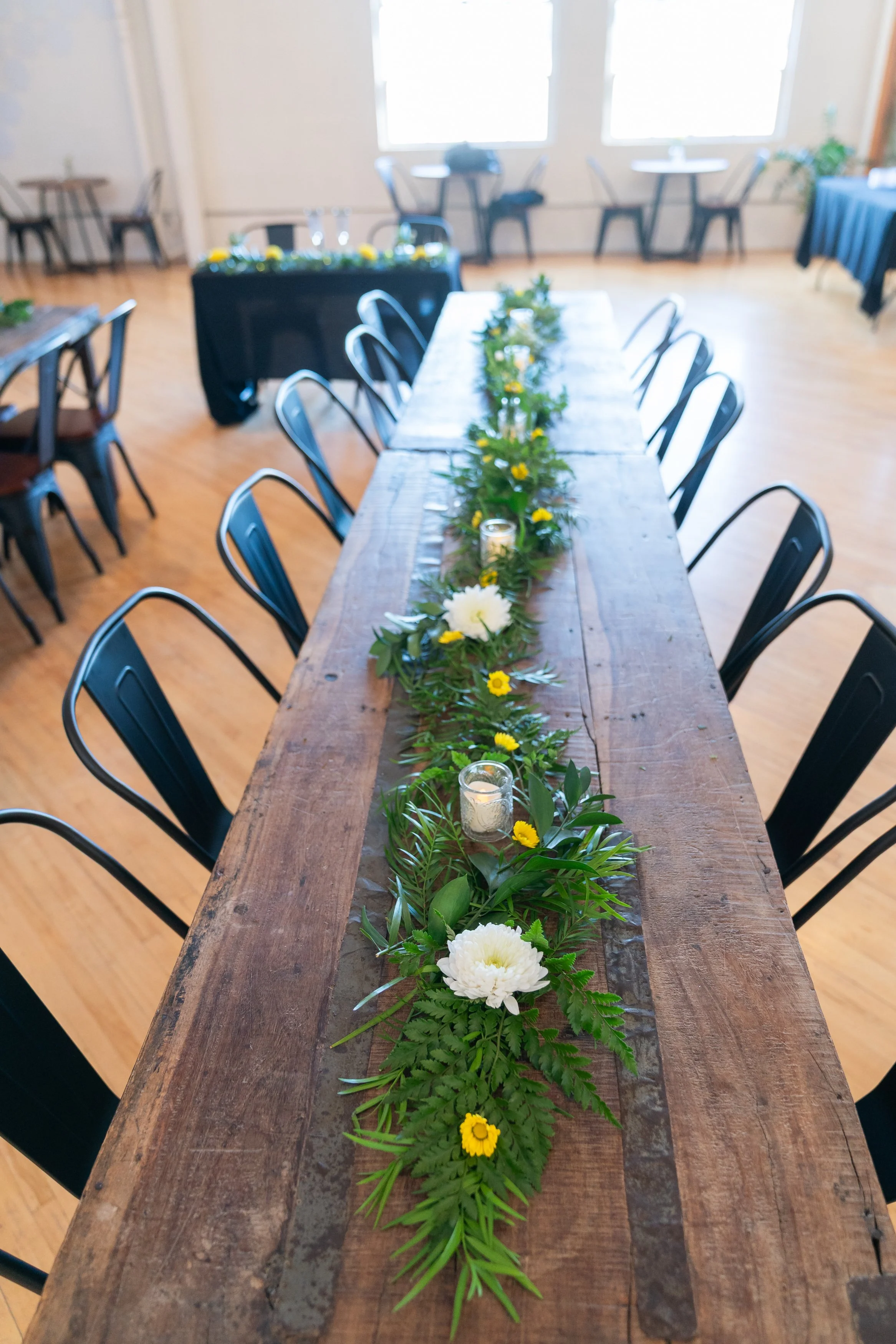 Elopement Package greenery on center of rustic wedding tables