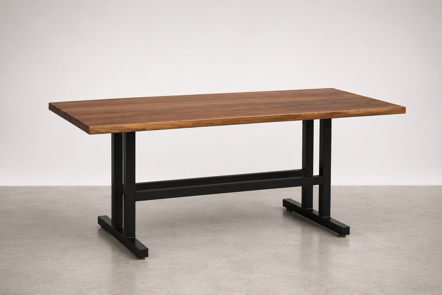 Wooden table with black metal frame on a plain light-colored floor against a white background.