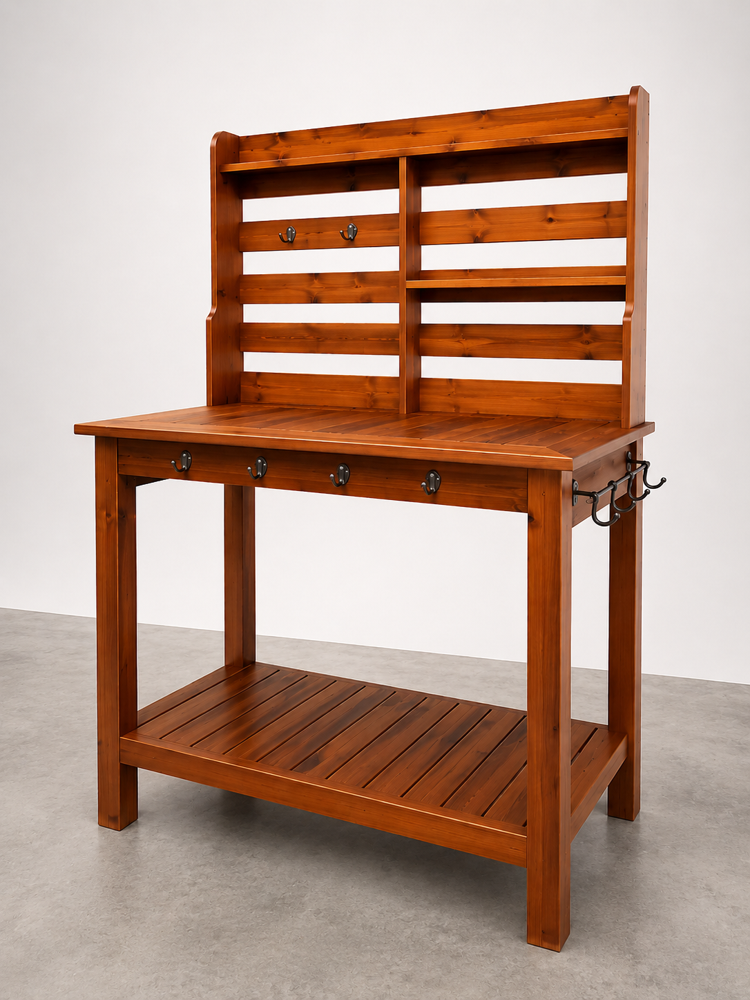 A wooden workbench with a slatted backboard, hooks, and a lower shelf, made of stained wood.