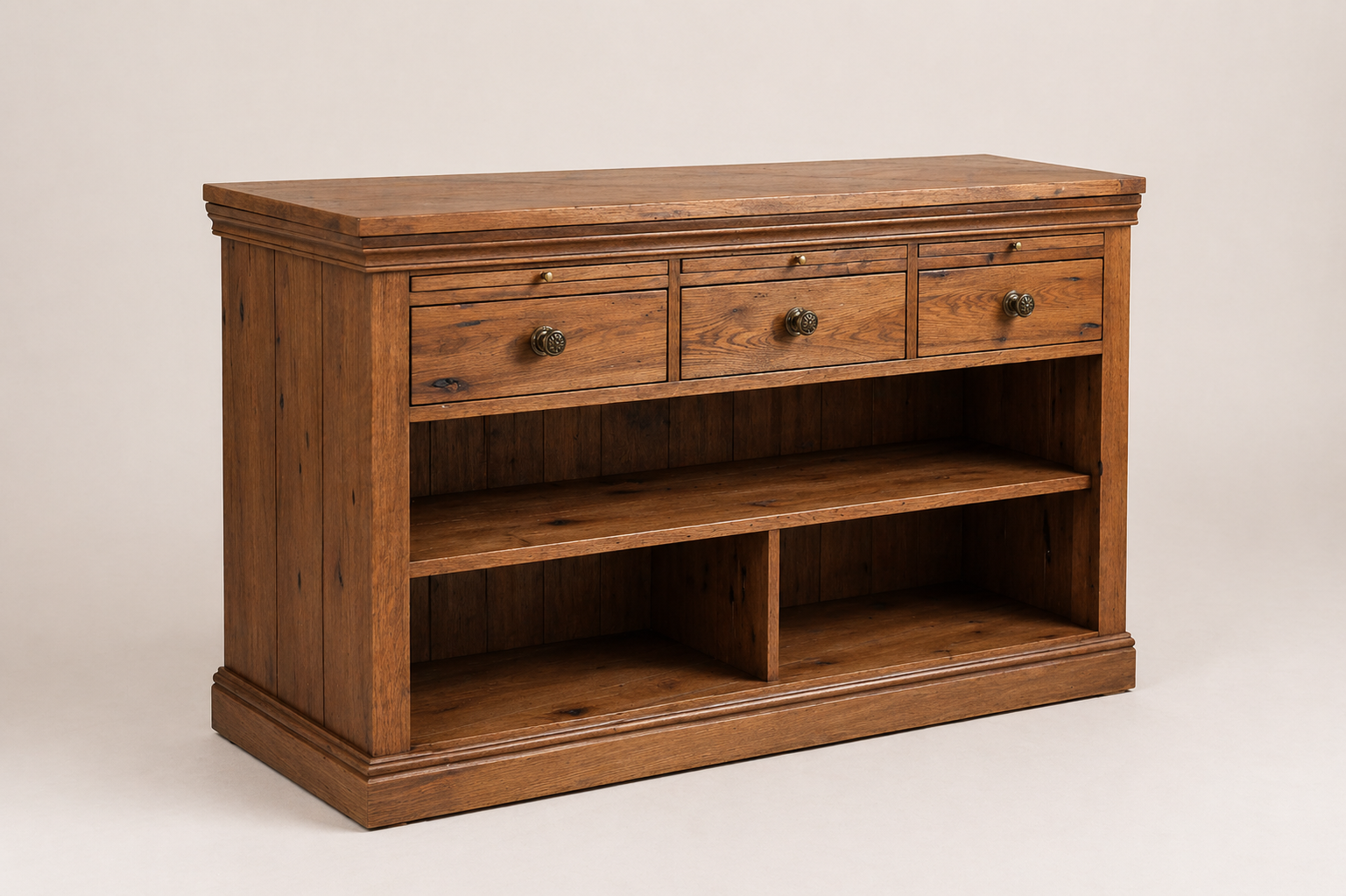 Wooden console table with three drawers and two open shelves against a plain light background.