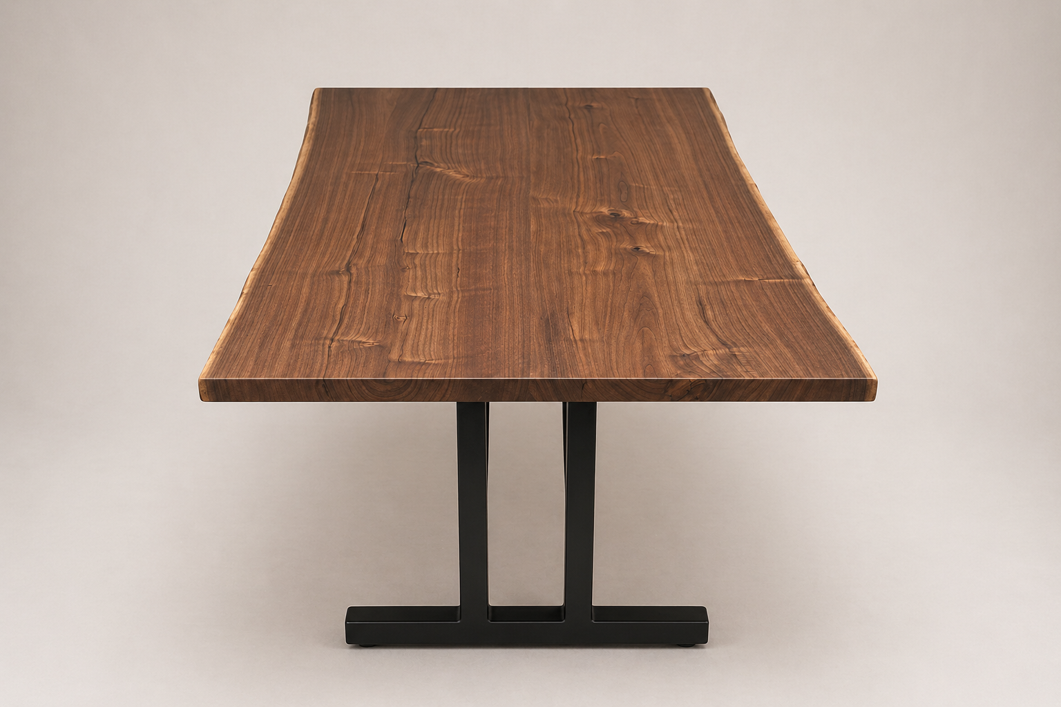 Wooden table with metal black legs against a plain neutral background.
