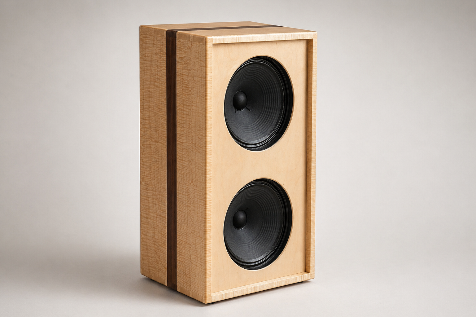 A tall curly maple speaker with two black drivers on a neutral background. Made by Von Boyle Woodworking Co.