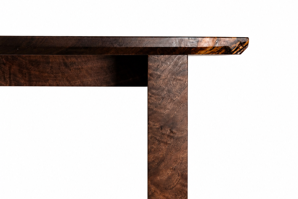 Close-up of a dark wood table corner with a white background.