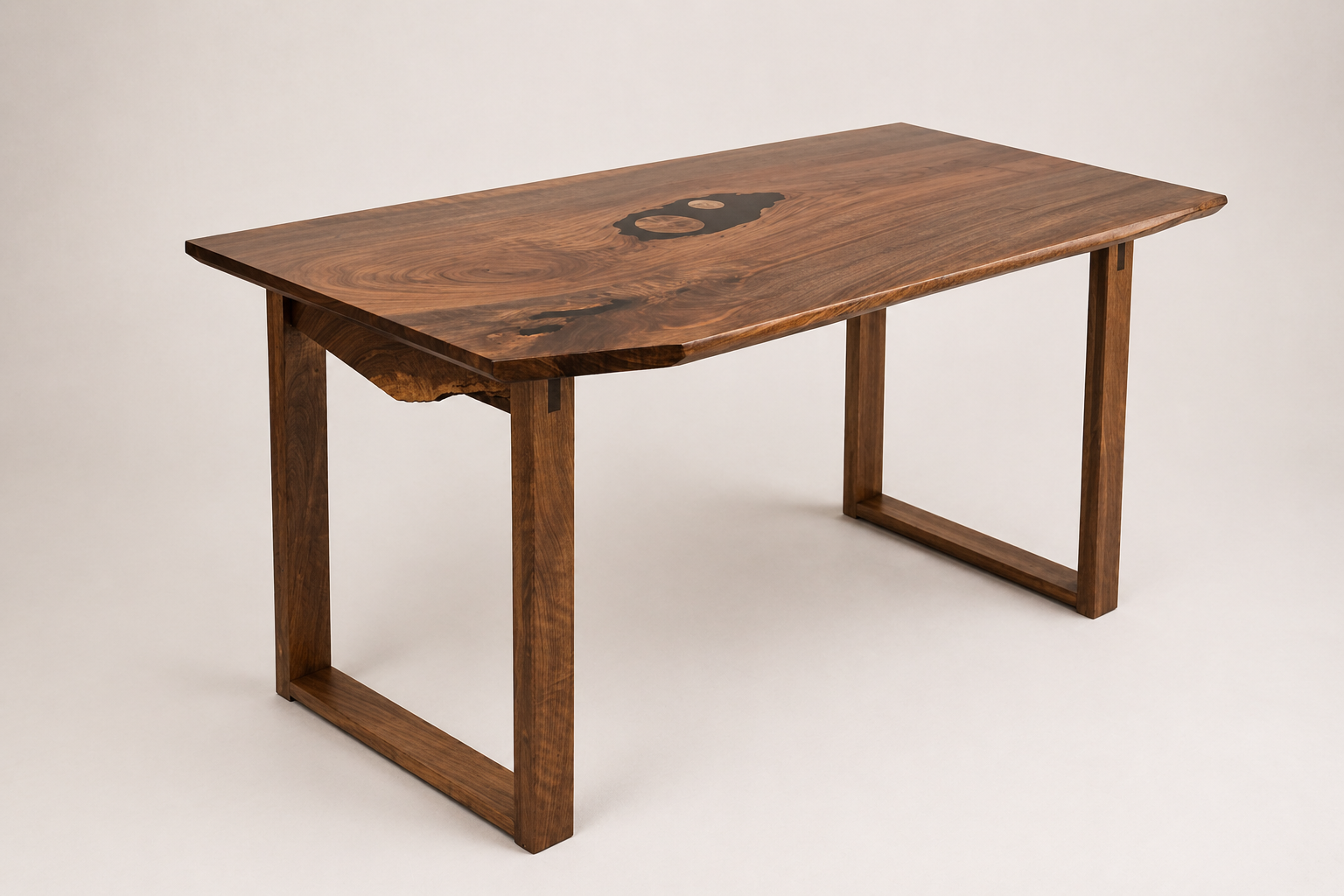 Wooden table with a live edge and unique dark wood grain pattern, against a plain light background.