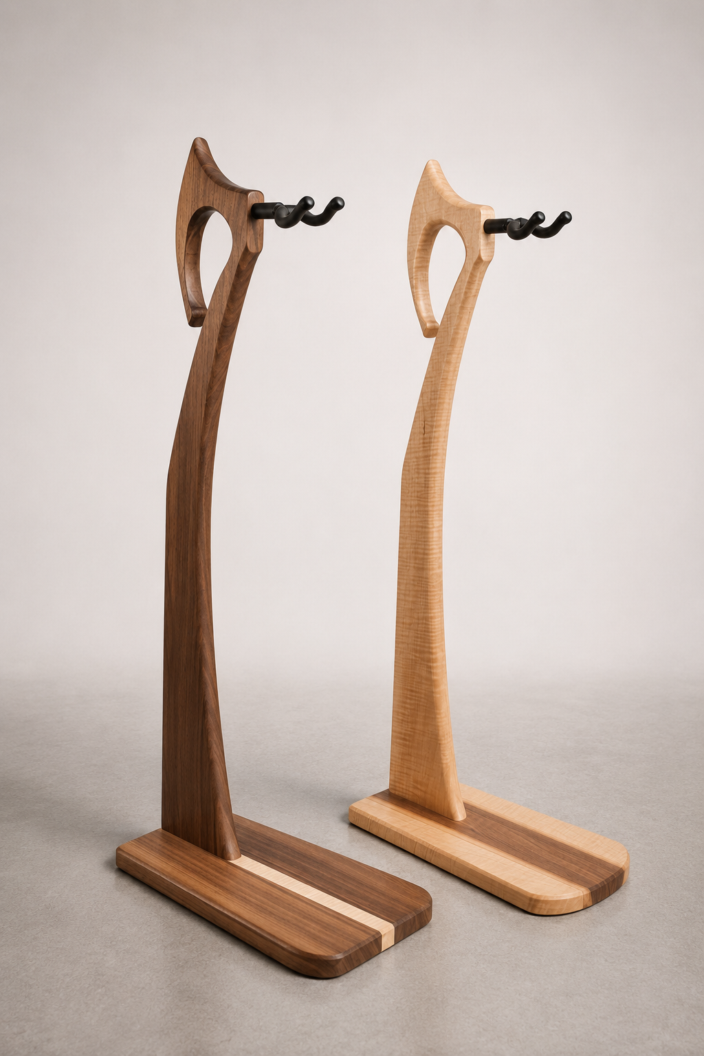 Two wooden coat racks with black hooks, one darker wood on the left and one lighter wood on the right, standing against a plain light gray background.