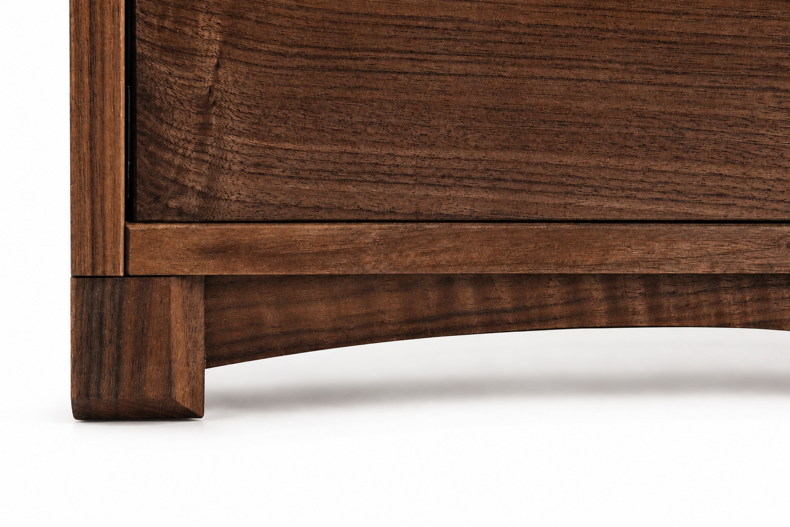 Close-up of a wooden furniture piece showing the leg and lower edge, made of dark brown wood with visible grain.