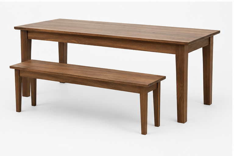 A wooden walnut dining table with tapered legs a matching wooden bench with tapered legs against a plain white background.