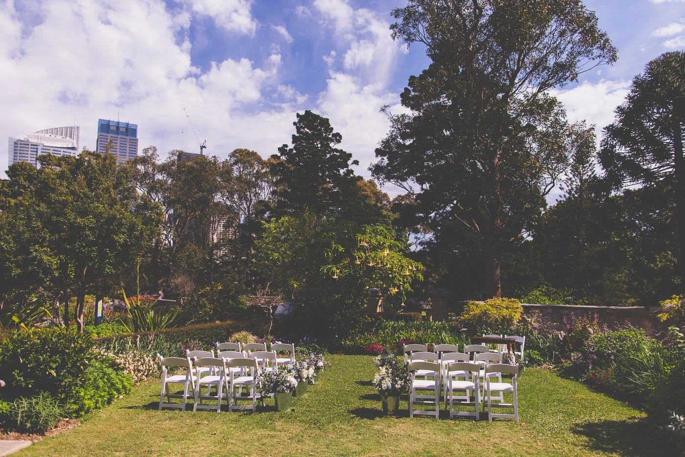 Wedding at Lion Gate Lodge with white chairs and buckets of flowers