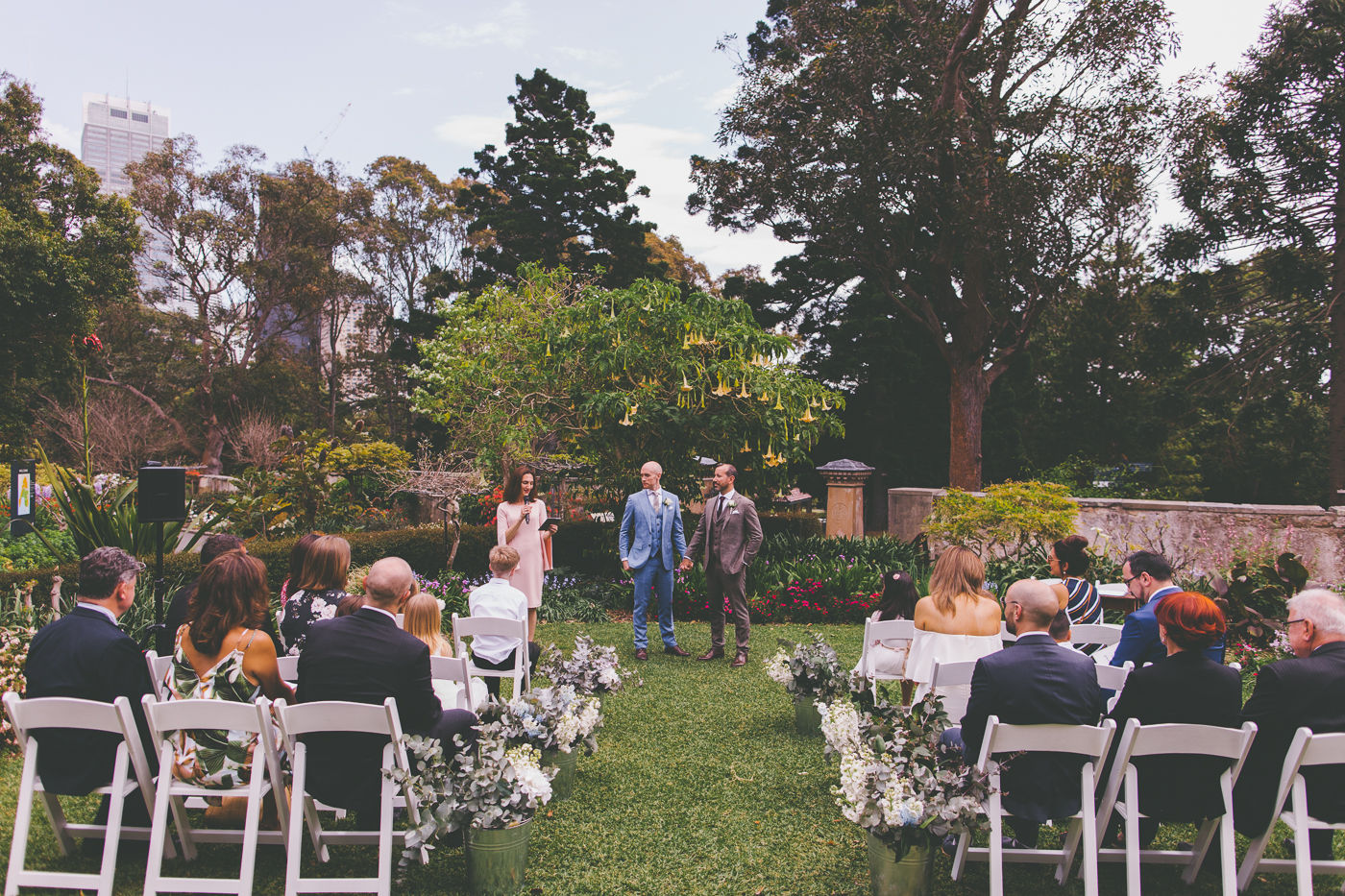 Wedding ceremony at Lion Gate Lodge planned by Wedding Planner Samantha Burke Events. Buckets of flowers.