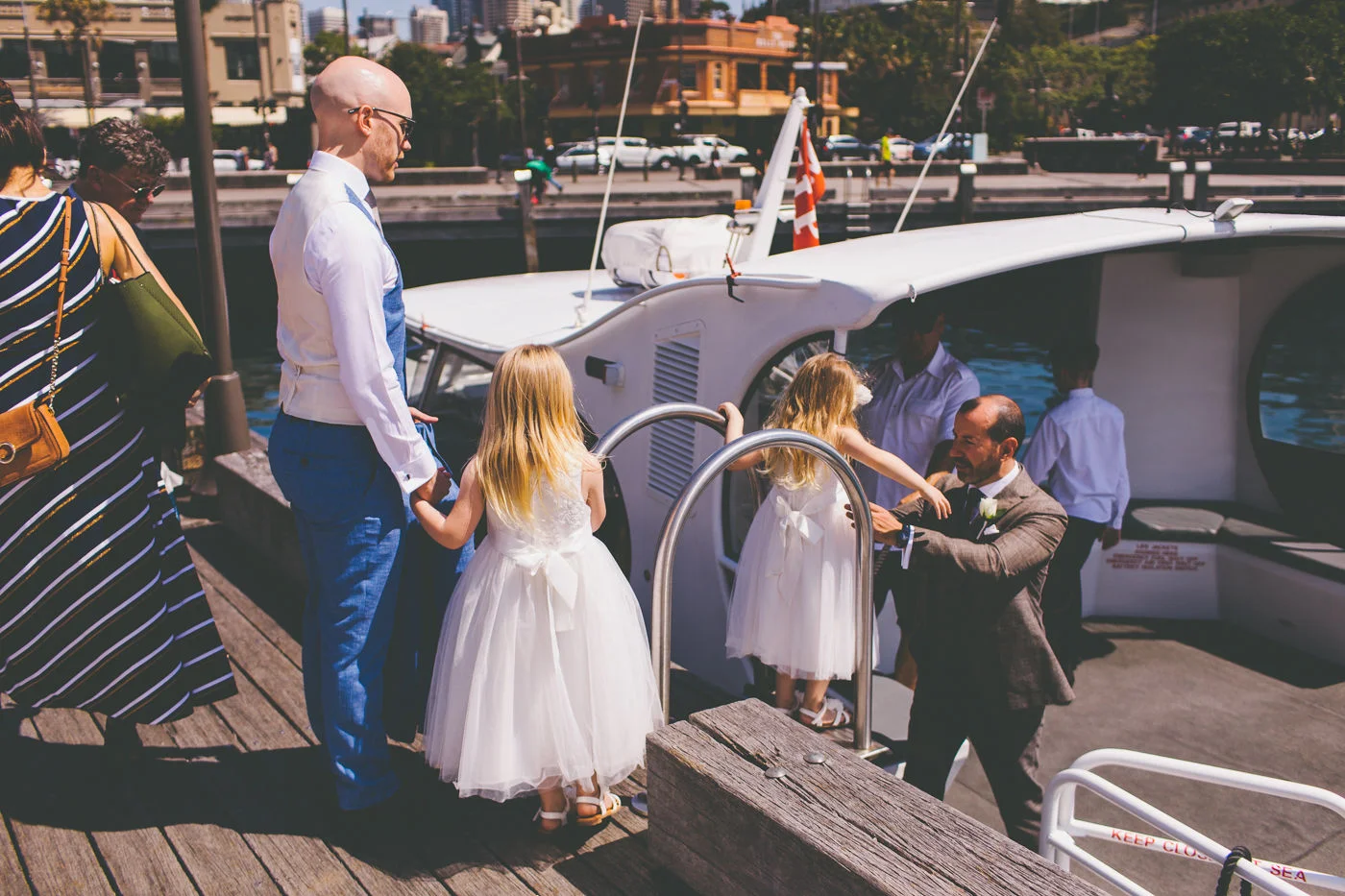 Grooms and flower girls getting on boat. Wedding Planner Sydney.