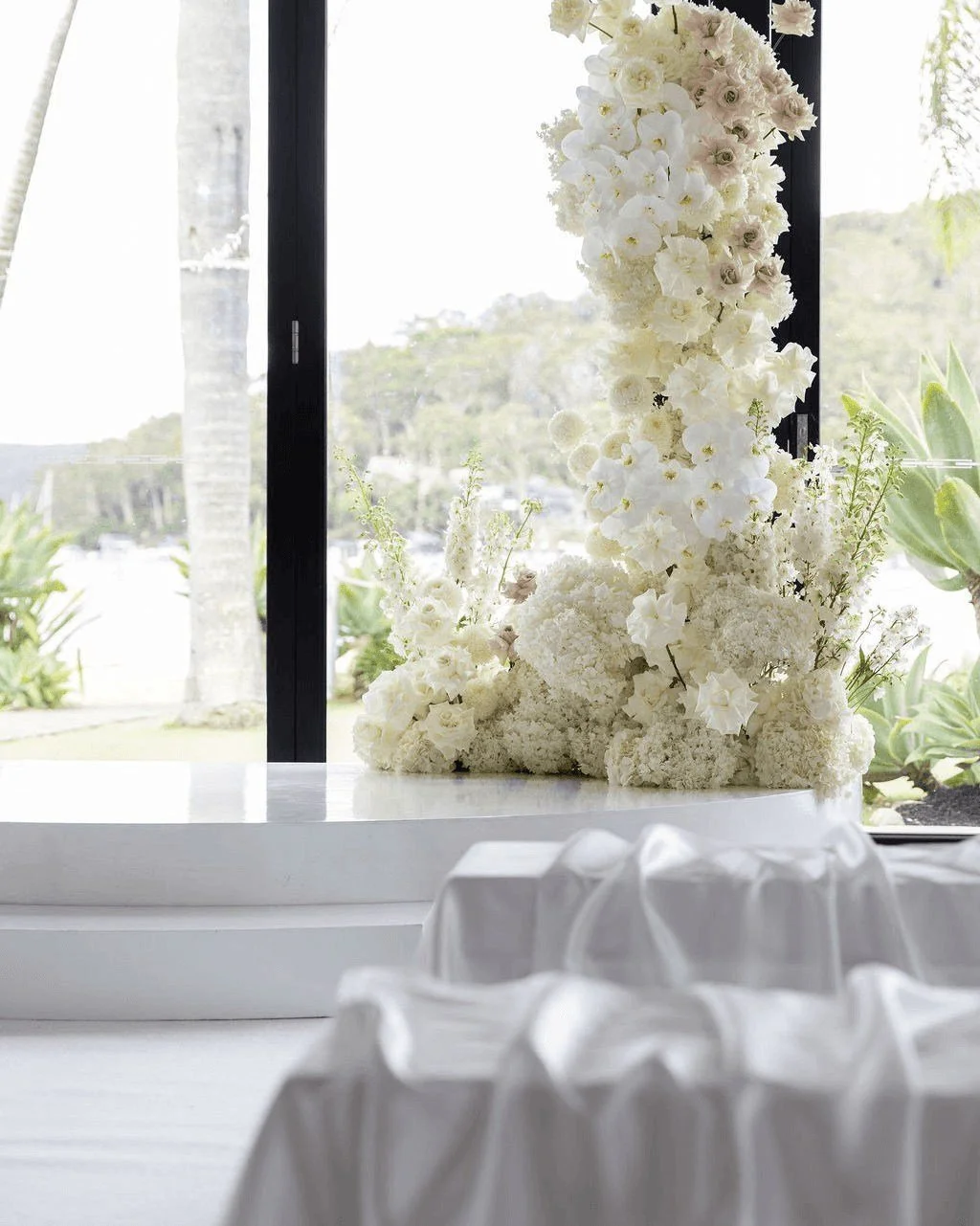 A ceremony that felt effortlessly elegant and full of heart ✨
White florals, flowing seat draping, a clean white aisle, and a softly styled stage created a timeless setting, brought to life with live string music as Jordan &amp; Joe exchanged vows an