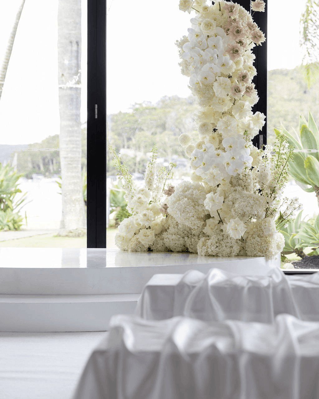 A ceremony that felt effortlessly elegant and full of heart ✨
White florals, flowing seat draping, a clean white aisle, and a softly styled stage created a timeless setting, brought to life with live string music as Jordan &amp; Joe exchanged vows an