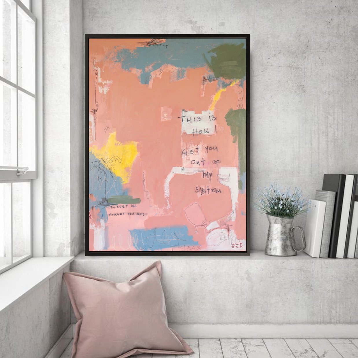 Framed abstract pink artwork on shelf next to window and decor