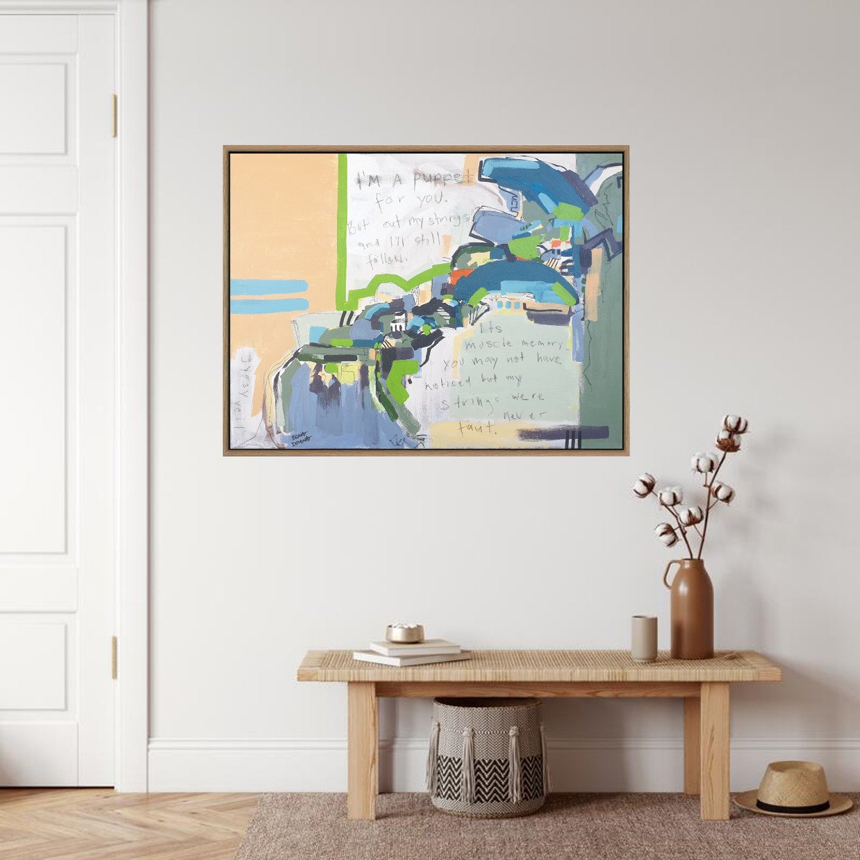 Framed abstract landscape with text on wall with bench and decor