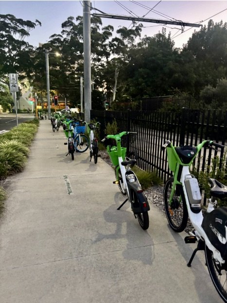 Shared e-micromobility bicycles scattered along shared path