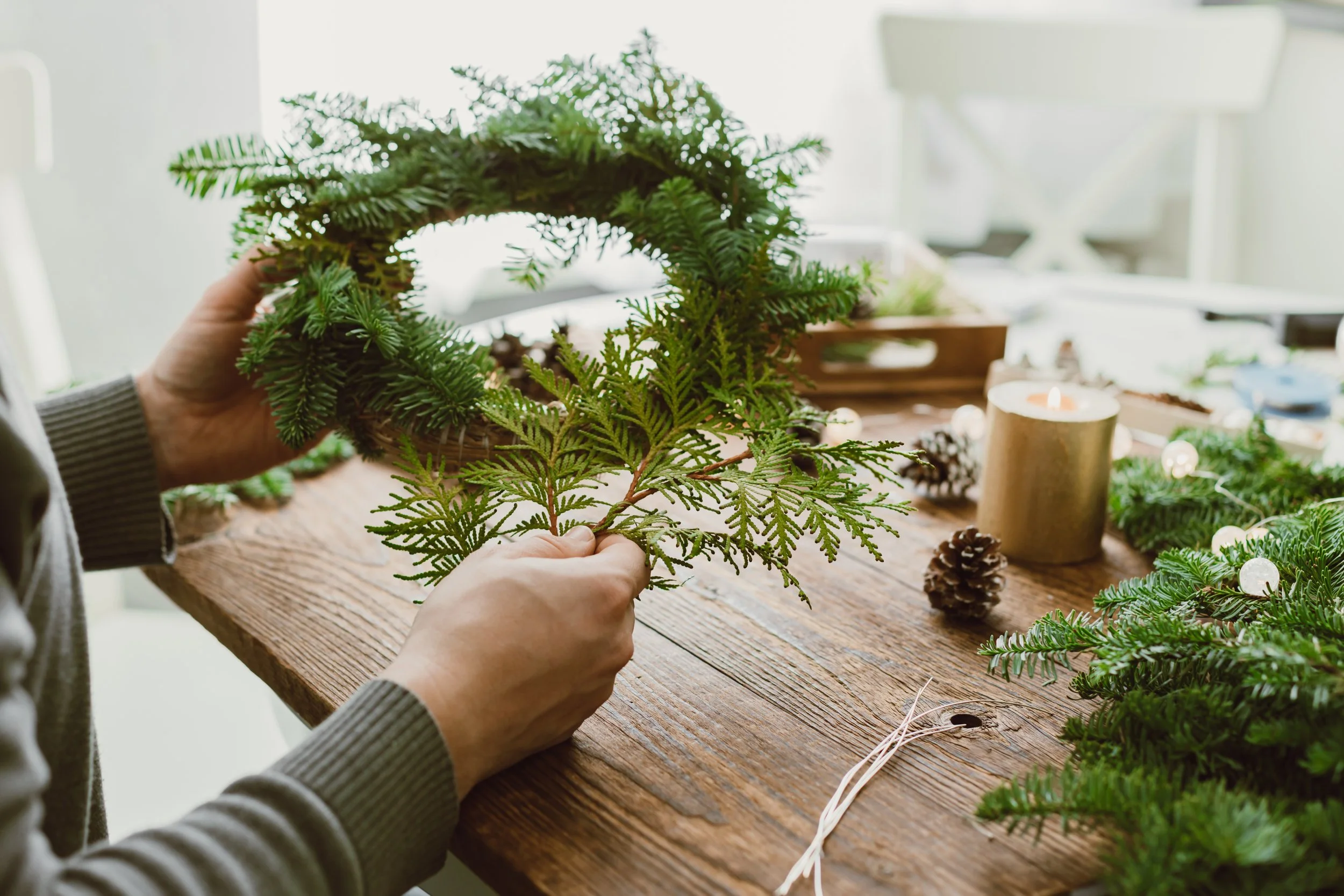 hands-male-florist-makes-new-years-drenching-from-fresh-spruce-branches-cones-dried-fruits.jpg