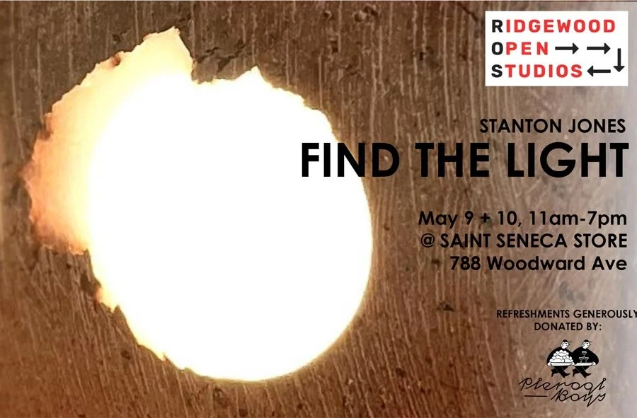 Flyer with a hole in a wooden surface emitting light. Text advertises 'Find the Light' event on May 9-10-11 at Saint Seneca Store, 788 Woodward Ave. Includes details and sponsor logos.
