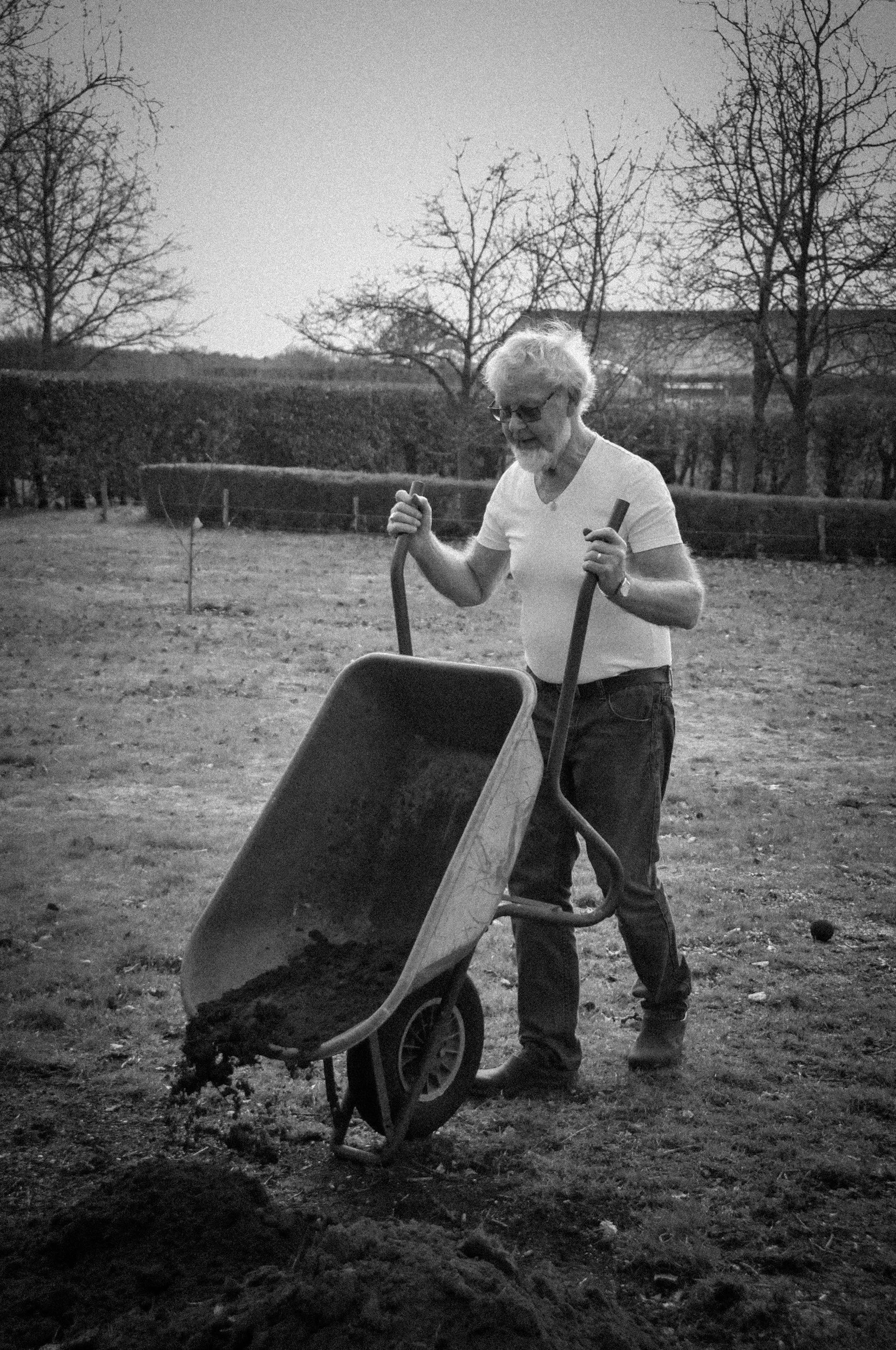 Man using wheelbarrow in garden