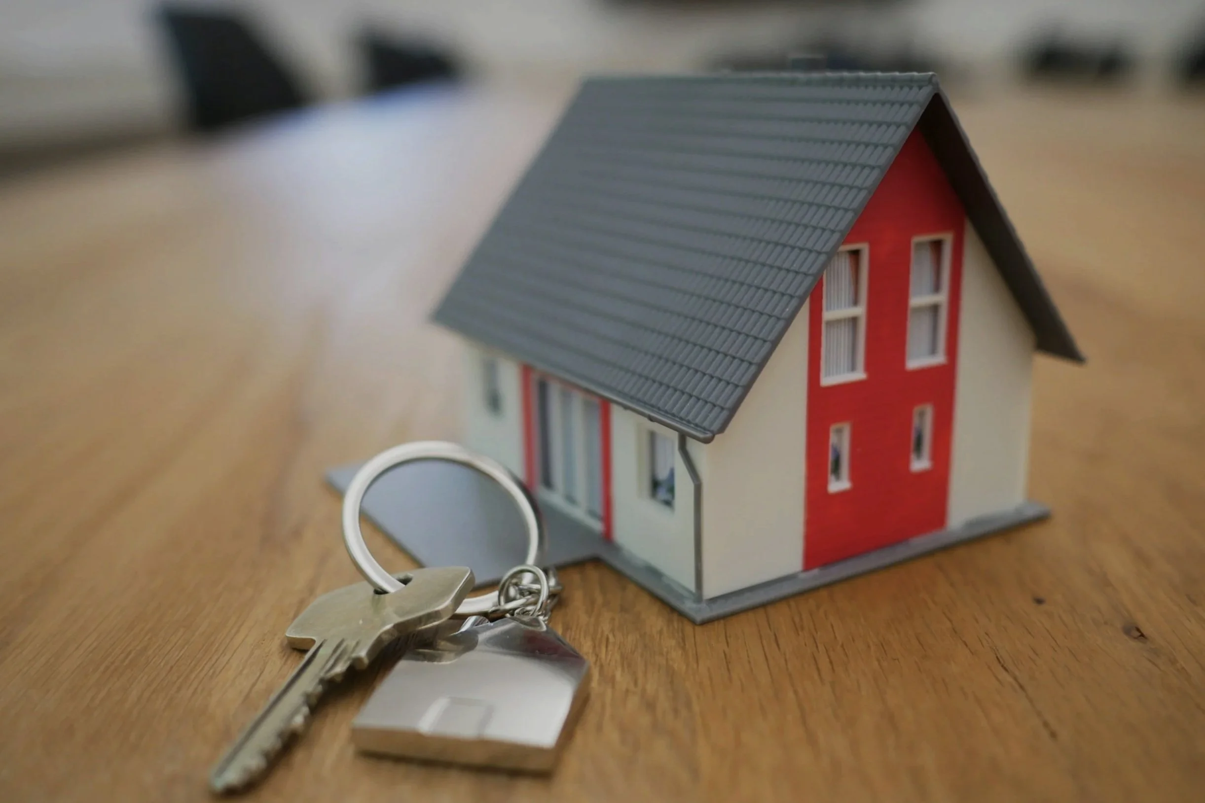 Image showing toy house and keys beside it, on a table