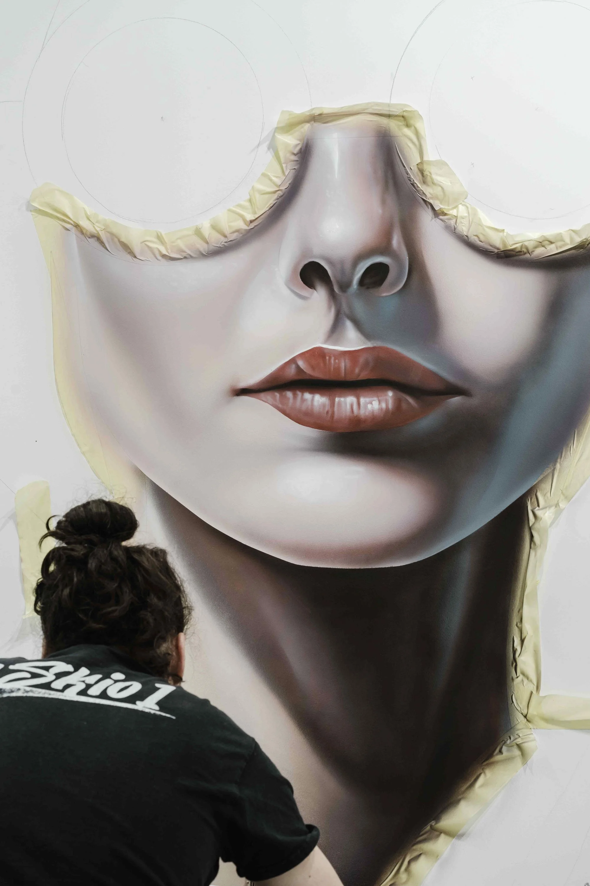 The artist at work, beginning the mural for the new Kiko Milano store in Paris.