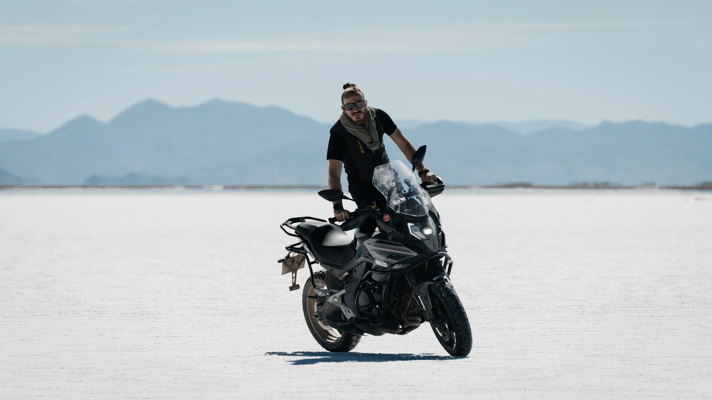 The CF Moto 800MT motorcycle standing on the infinite expanse of the Salinas Grandes salt flats, Argentina.