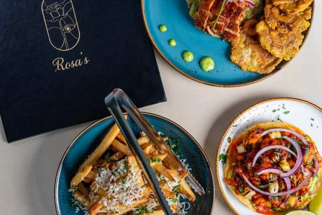 Best Mexican food in Toronto  platter with tacos, lime wedges, a side salad, and fried chicken with shredded lettuce on top