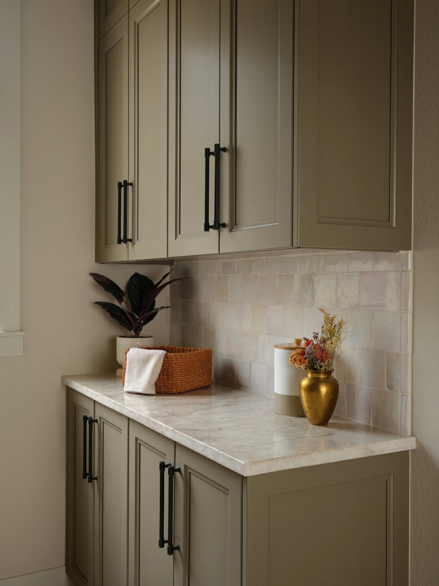 Pantry counter with pink cast zellige and Taj Mahal quartzite