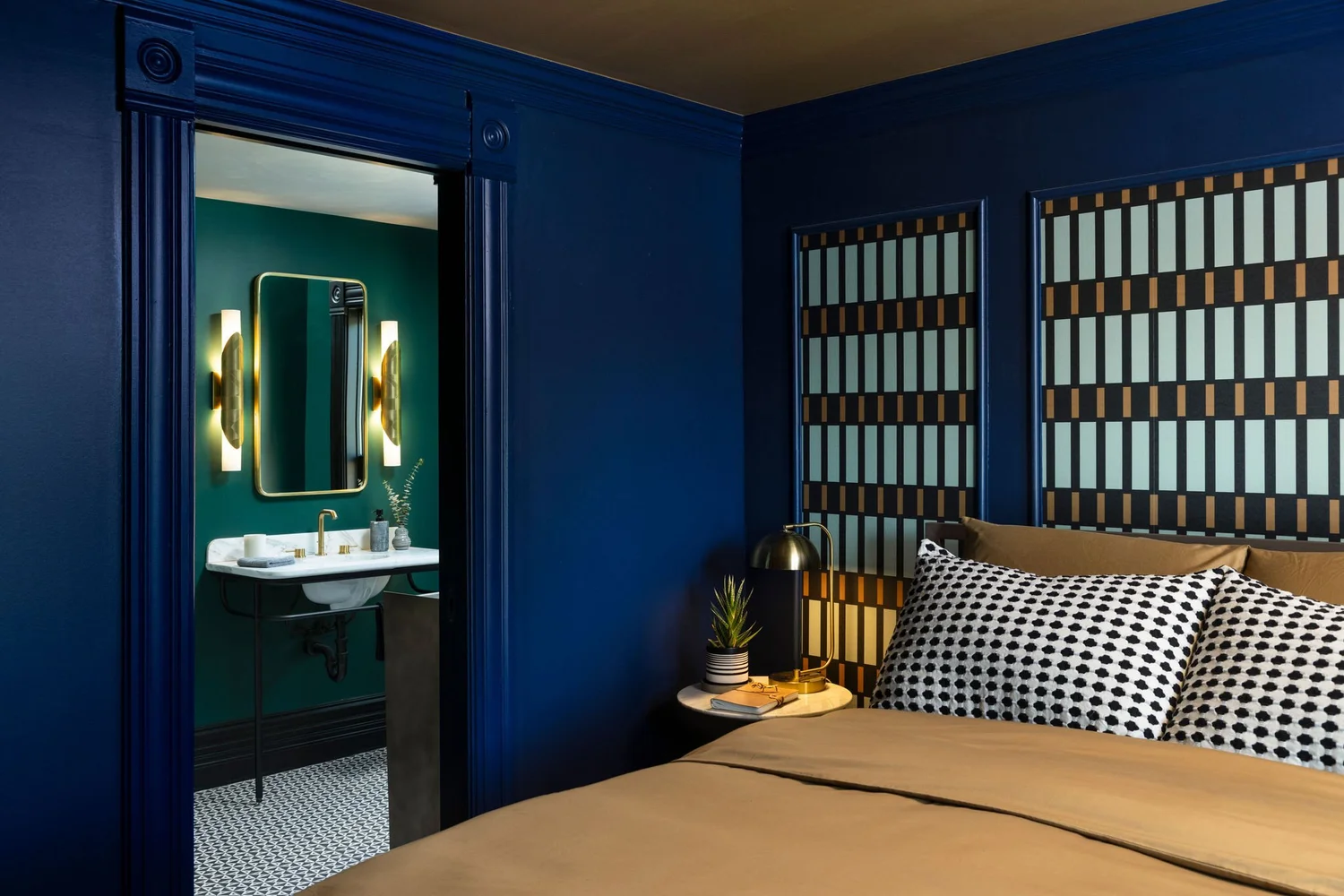 Navy guest bedroom looking through to the bath