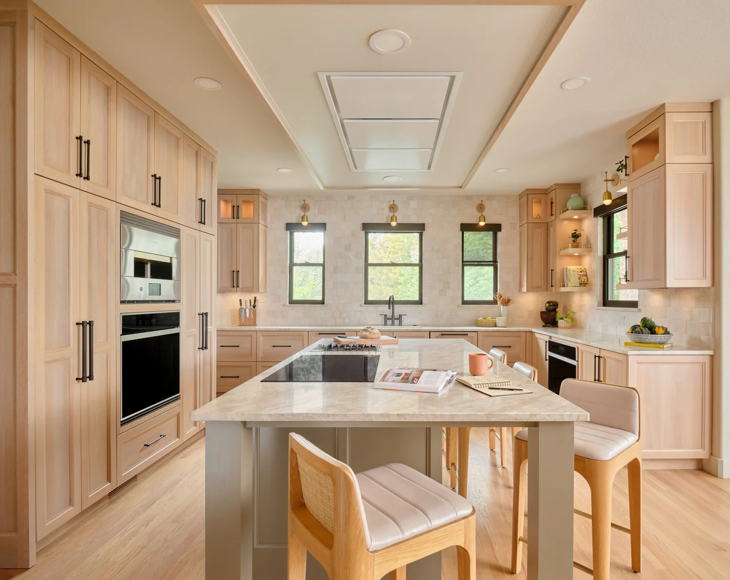 Kitchen after renovation, the white oak island beneath the cloud with a flush ceiling hood