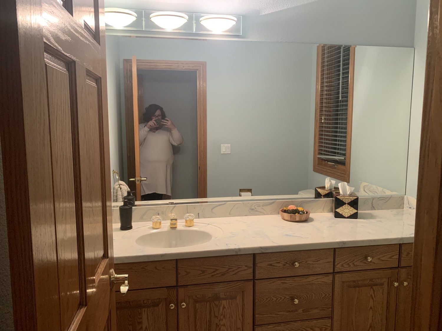 The original powder bath with a long vanity and blue walls