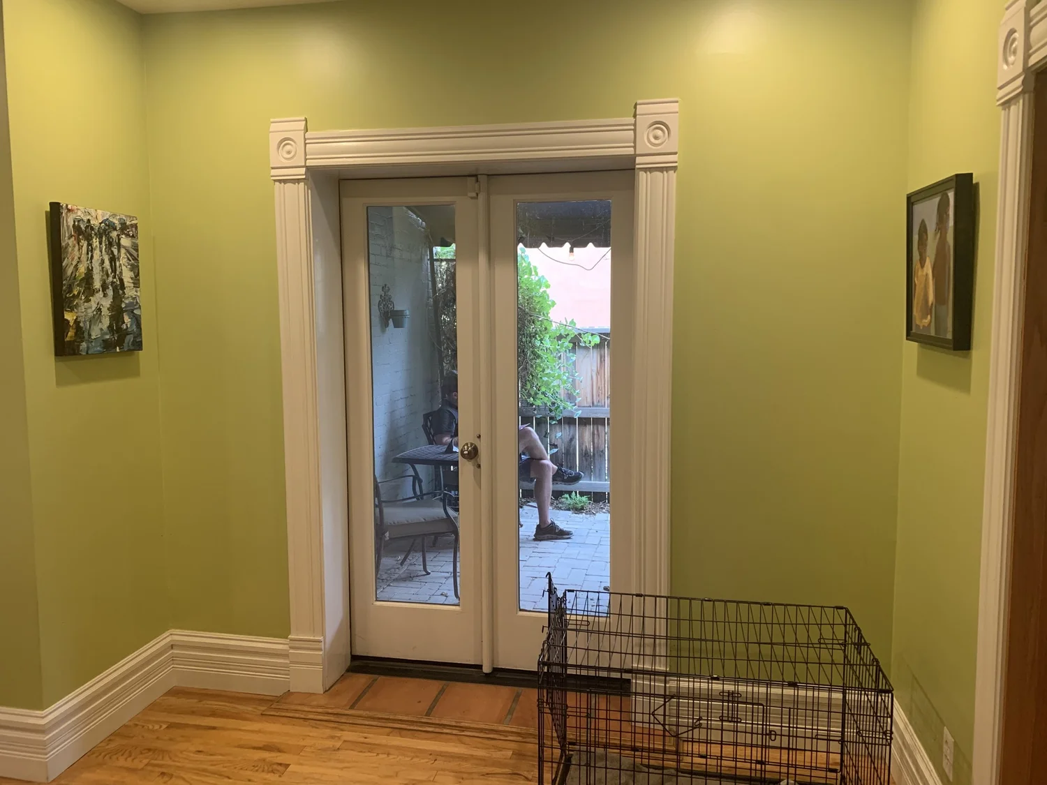 Dining room before renovation, green walls and French doors to the patio