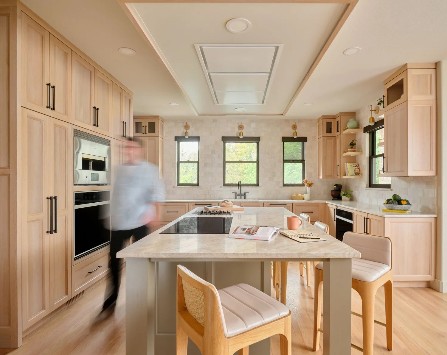 The kitchen in motion, with the cloud and flush hood overhead