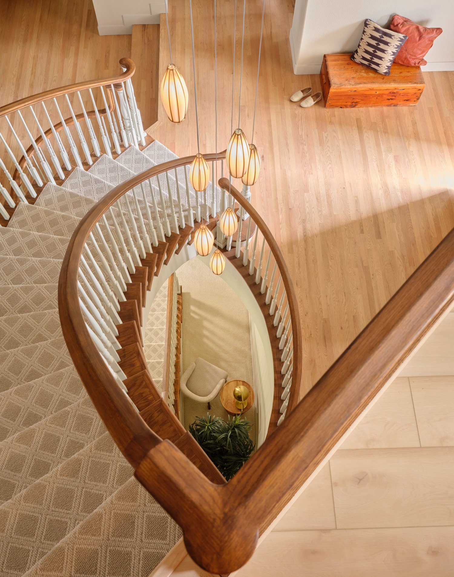 Lattice runner and painted balusters spiraling down to the basement