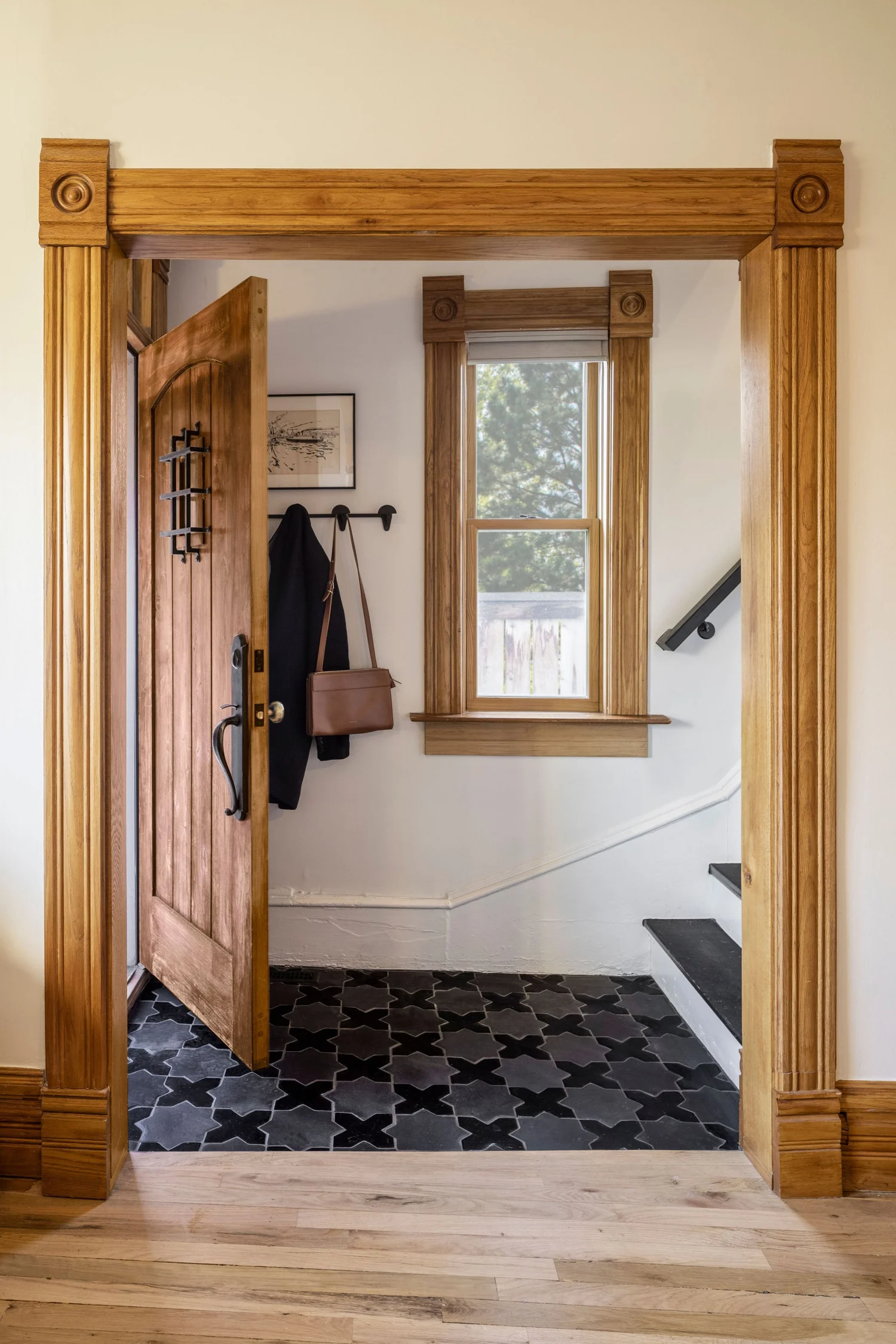 Foyer after renovation with black star and cross tile floor