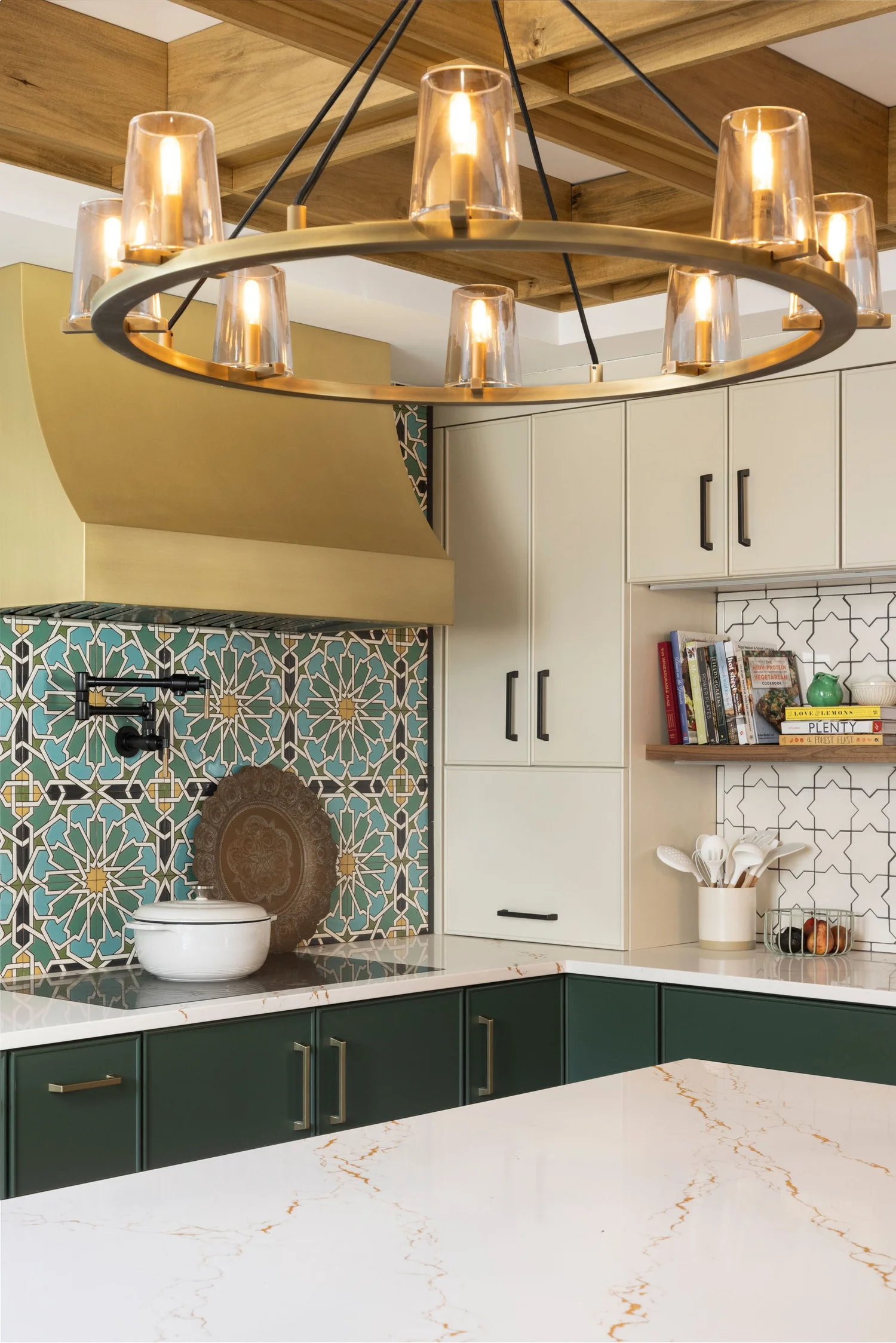 Brass ring chandelier over the island, with the brass hood and the walnut cookbook shelf
