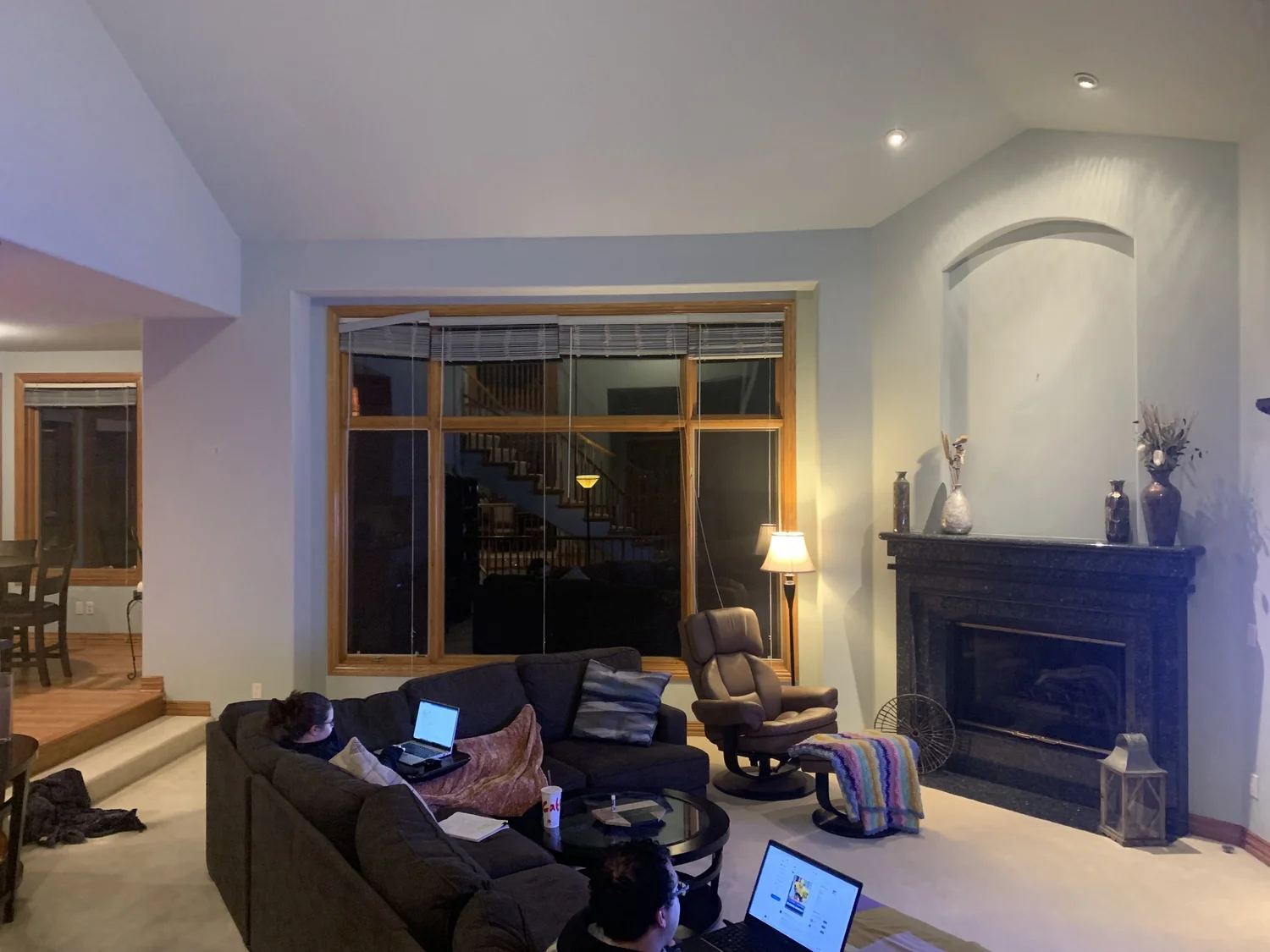 The original living room with a granite fireplace surround