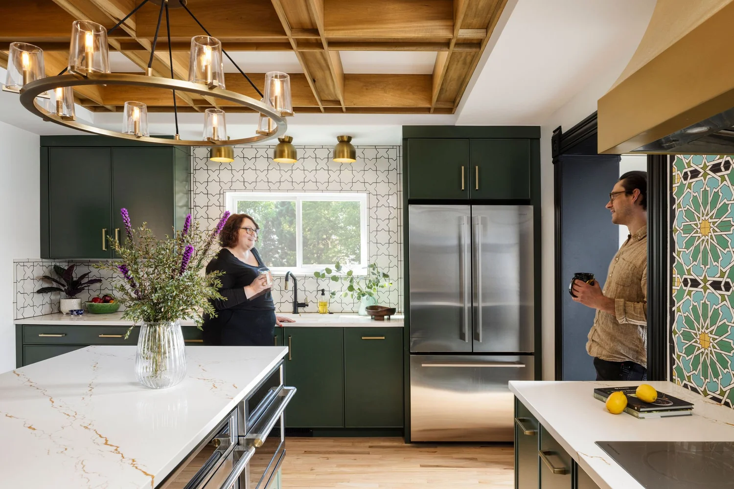 Ashley and Lars in the finished kitchen beneath the coffered ceiling