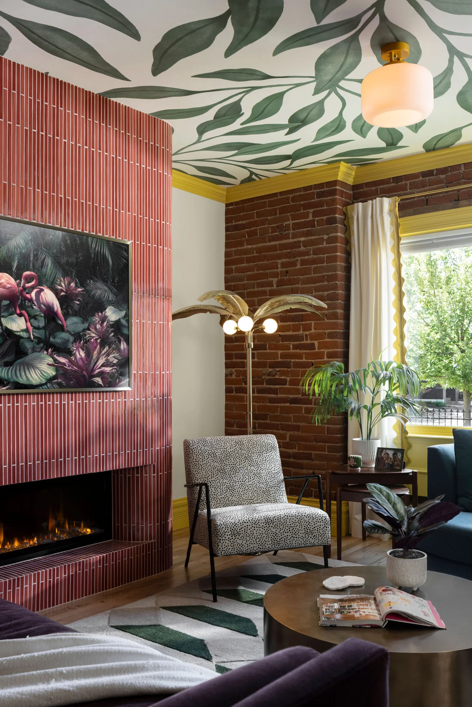 Pink tile fireplace against the original exposed brick wall