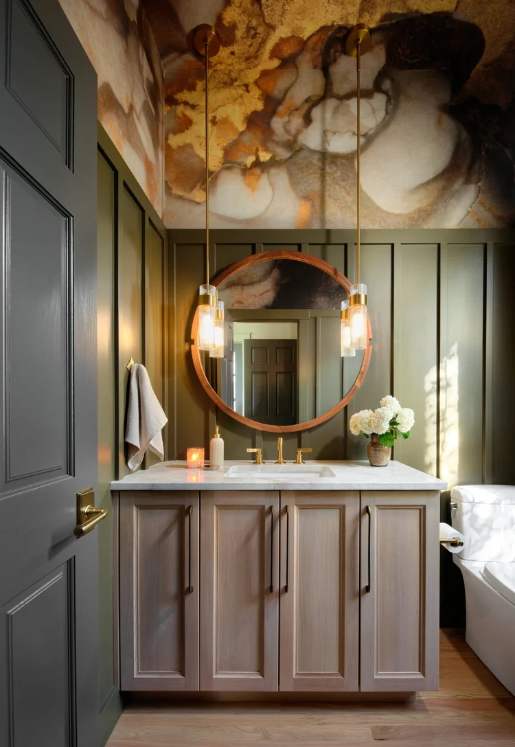 Powder bath at Head in the Clouds in Westminster, with a gold cloud mural over olive paneling