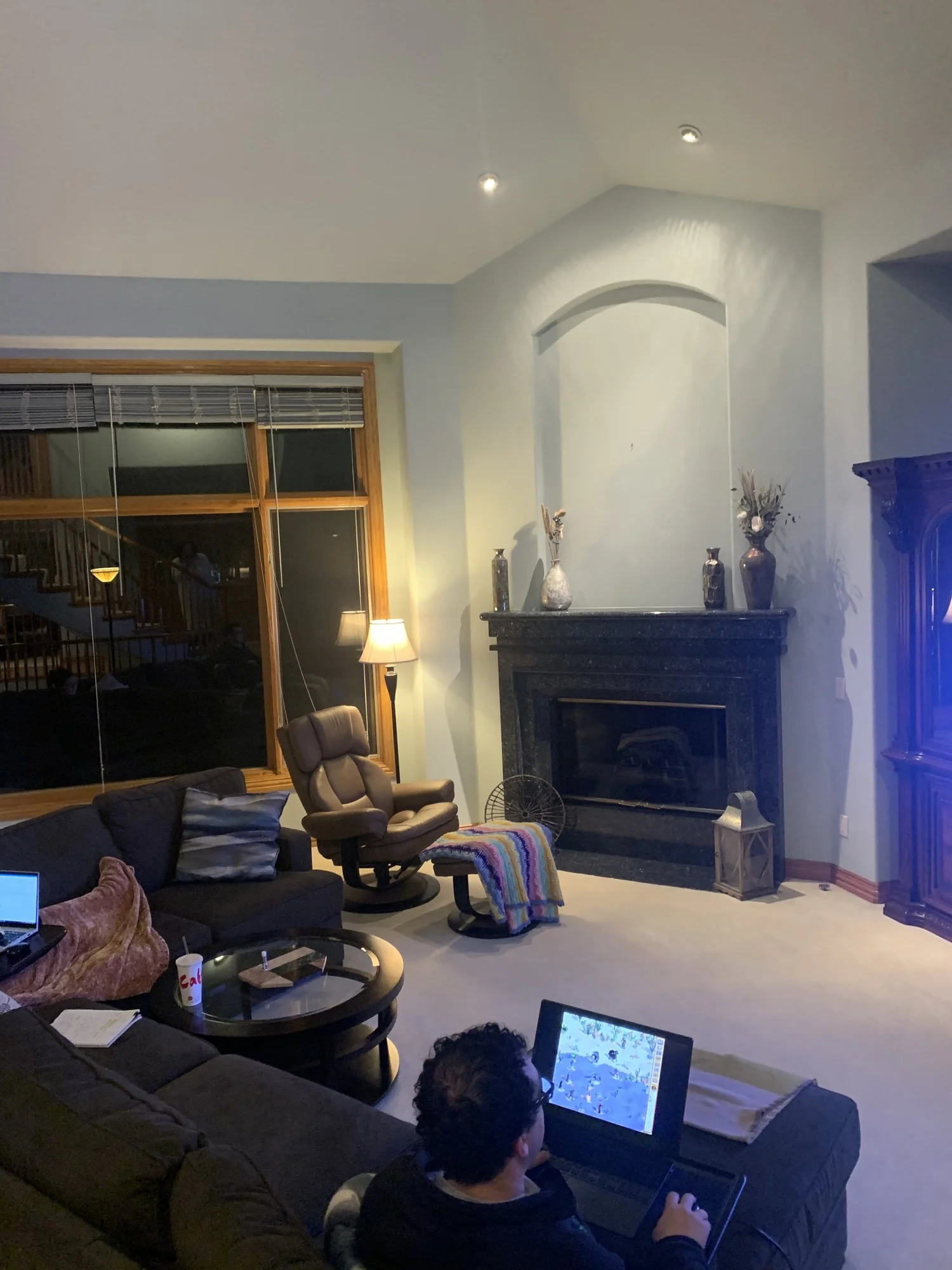 The original granite fireplace beneath an arched niche