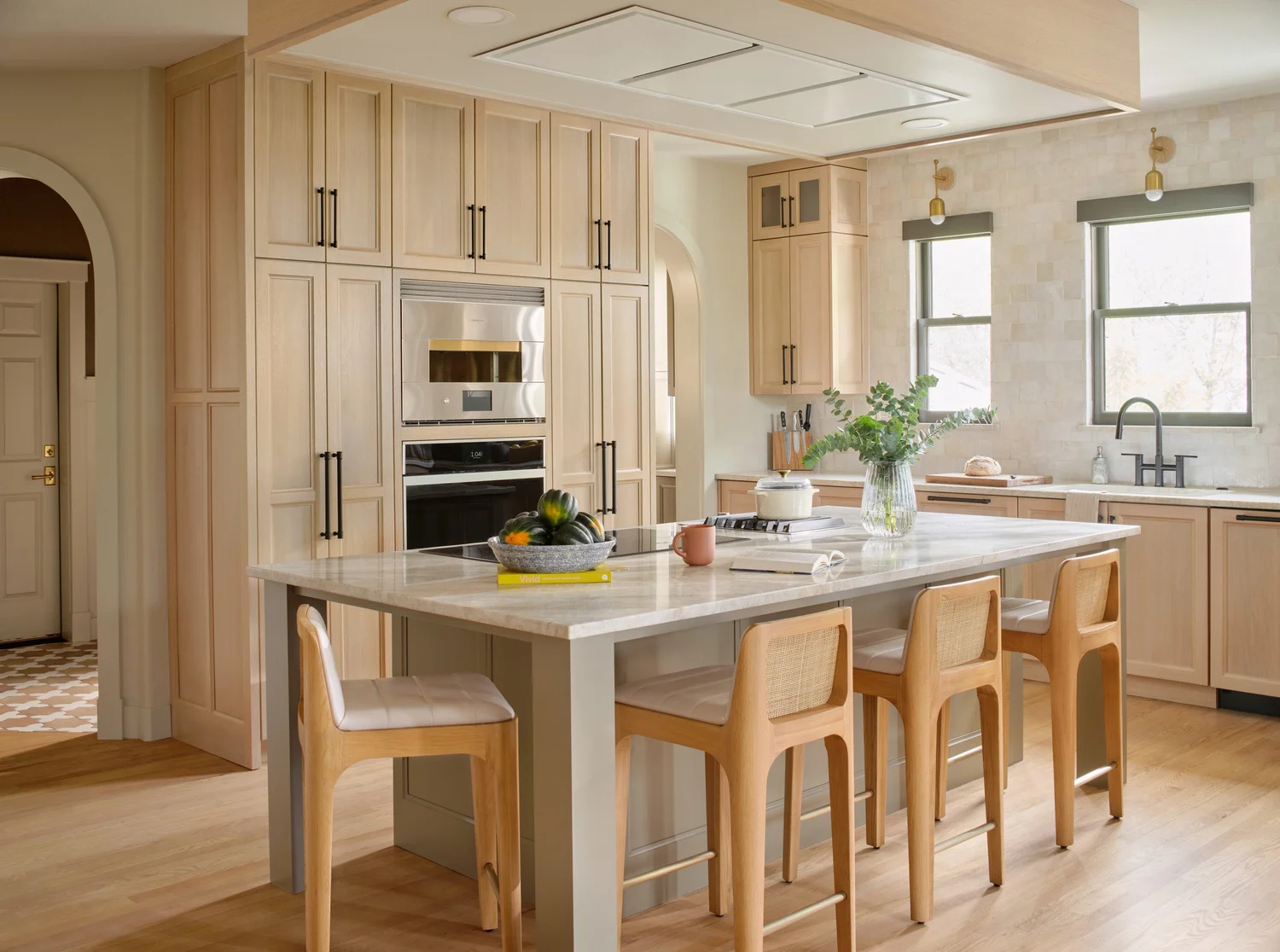 The tall white oak oven wall and the arched opening to the pantry