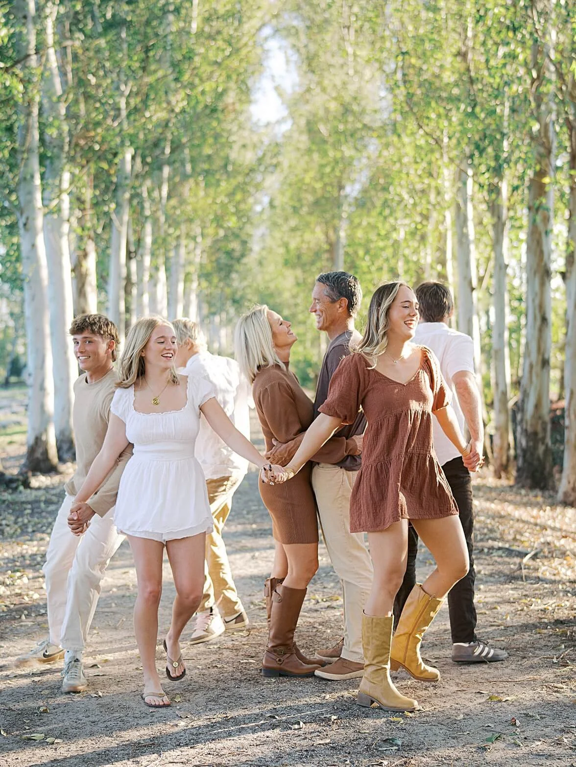 a happy family holding hands captured by jupiter family photographer Kristen Browning