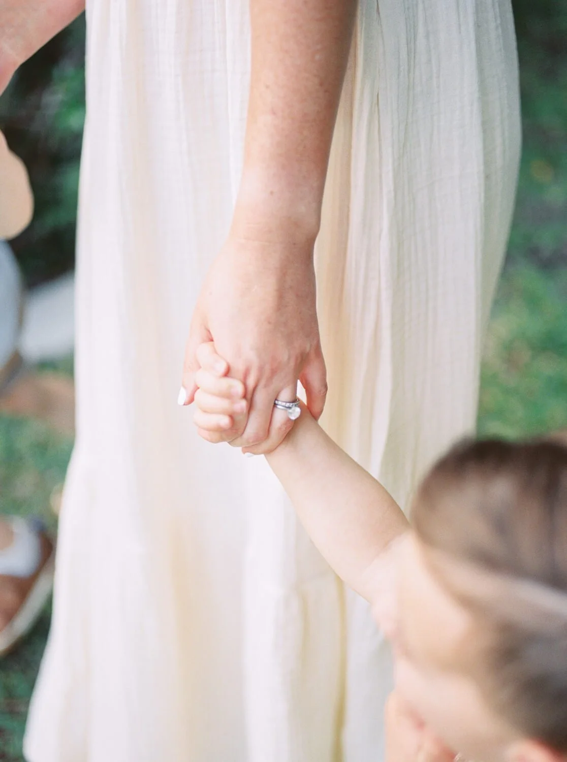 close up shot of mom holding hands with son captured by west palm beach family photographer kristen browning