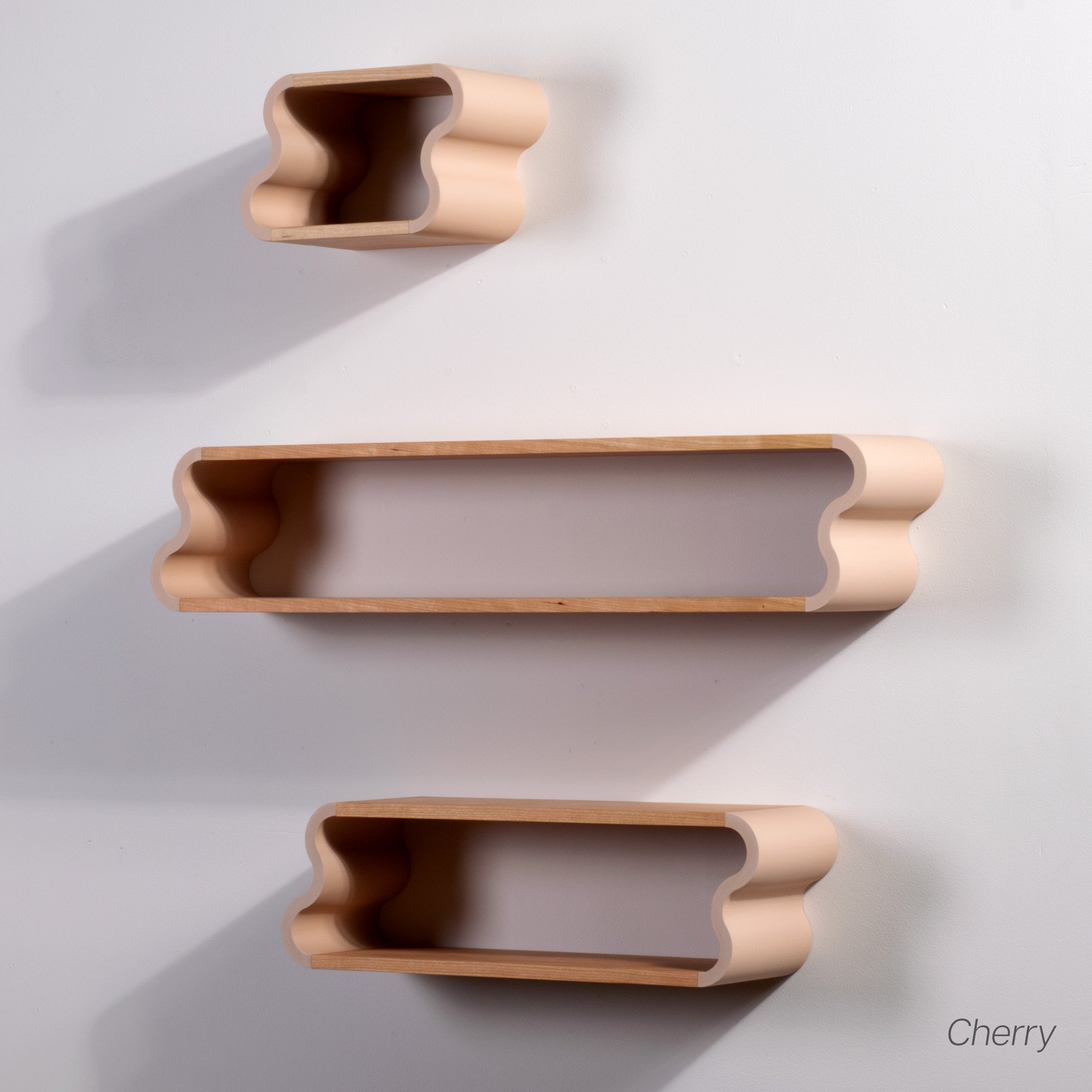 Set photo of cherry and pastel pink Squiggle Floating Shelves | Pastel Accented Cherry and Ash Hardwood Shelving | Modular Display & Storage | Floating Shelving | Wall Shelf