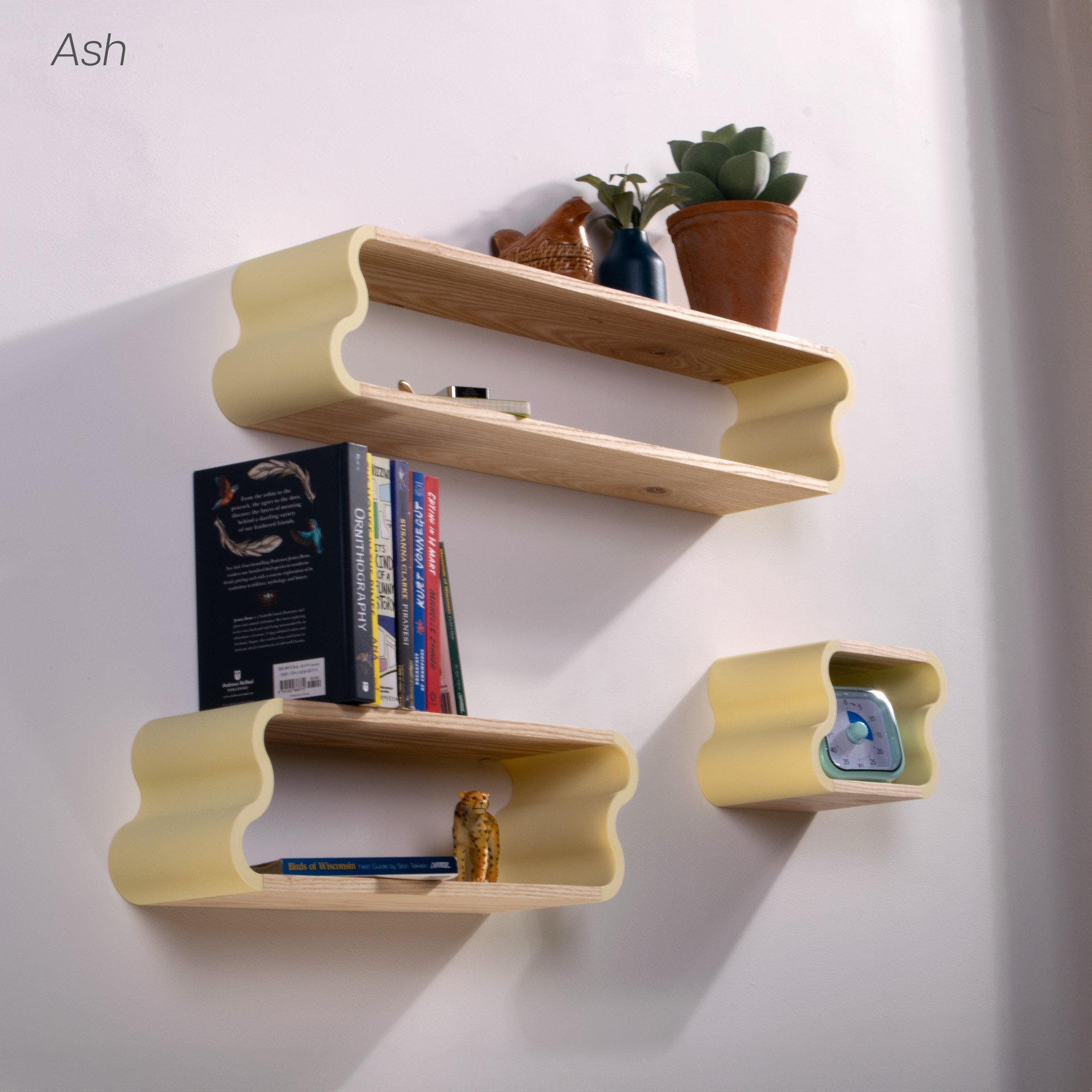 In use photo of ash and pastel yellow Squiggle Floating Shelves | Pastel Accented Cherry and Ash Hardwood Shelving | Modular Display & Storage | Floating Shelving | Wall Shelf