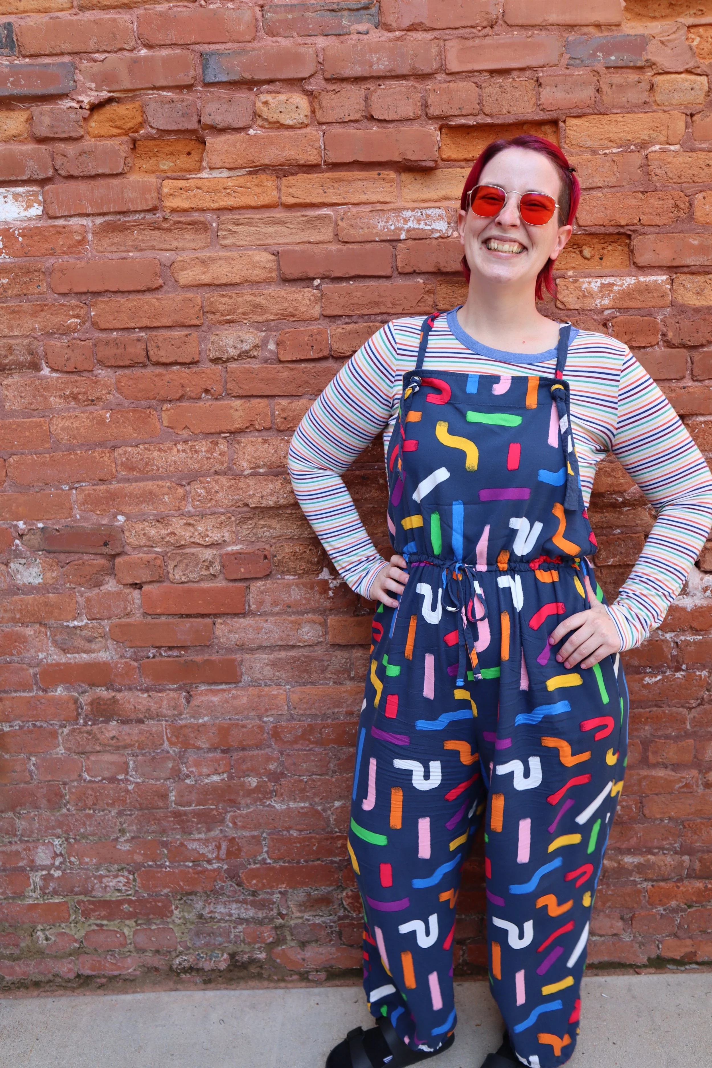 Photo of Heather Wilkerson smiling brightly in a well-lit coffee shop