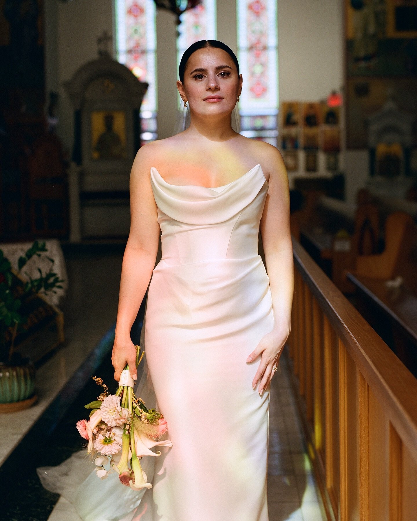 The stained glass light painted Nicole&rsquo;s dress in soft tones, while the bright Greek church interior felt like a natural studio &mdash; an editorial portrait destined to live in Nicole &amp; Jonathan&rsquo;s visual legacy for generations to com