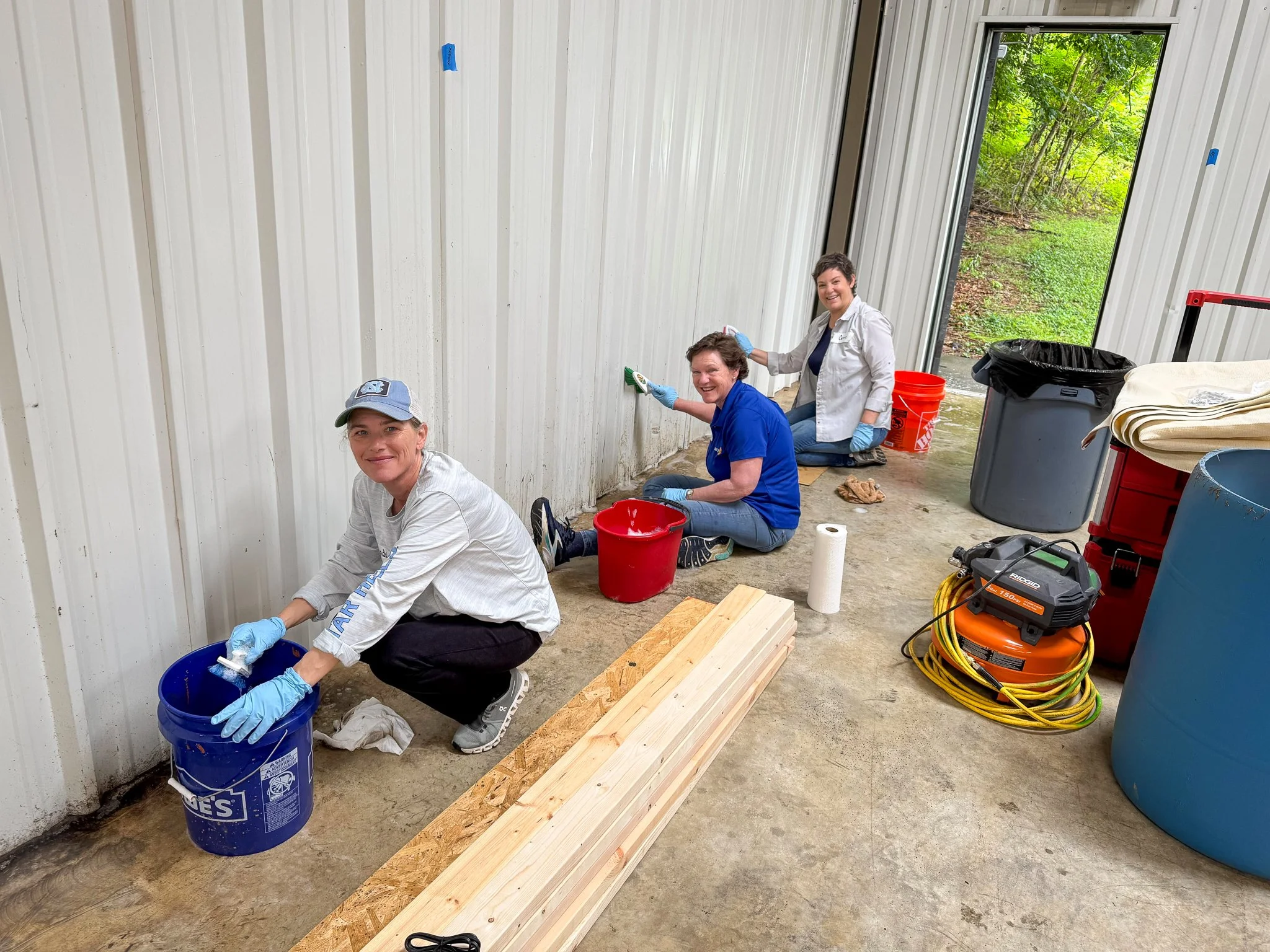  Hammer &amp; Heart volunteers help clean the program's new headquarters in Black Mountain, May 2026. 